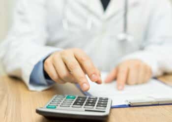 doctor is calculating cost of treatment
