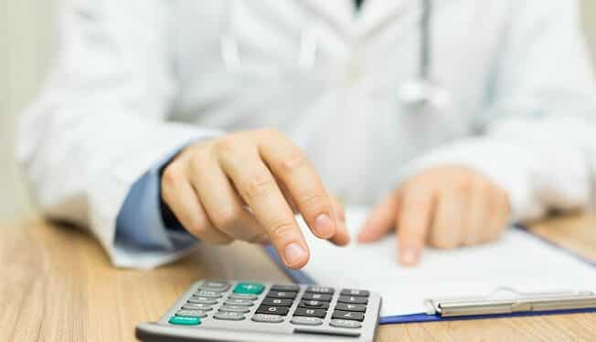 doctor is calculating cost of treatment